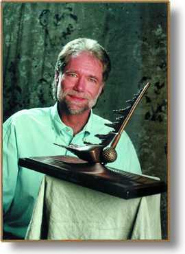 Stephen Lance Mellinger with one of his bronze golf sculptures
